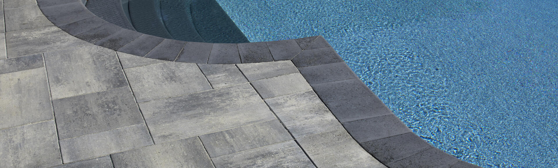 Pool and patio pavers using Nueva Slab and Cassina Coping products from Brampton Brick